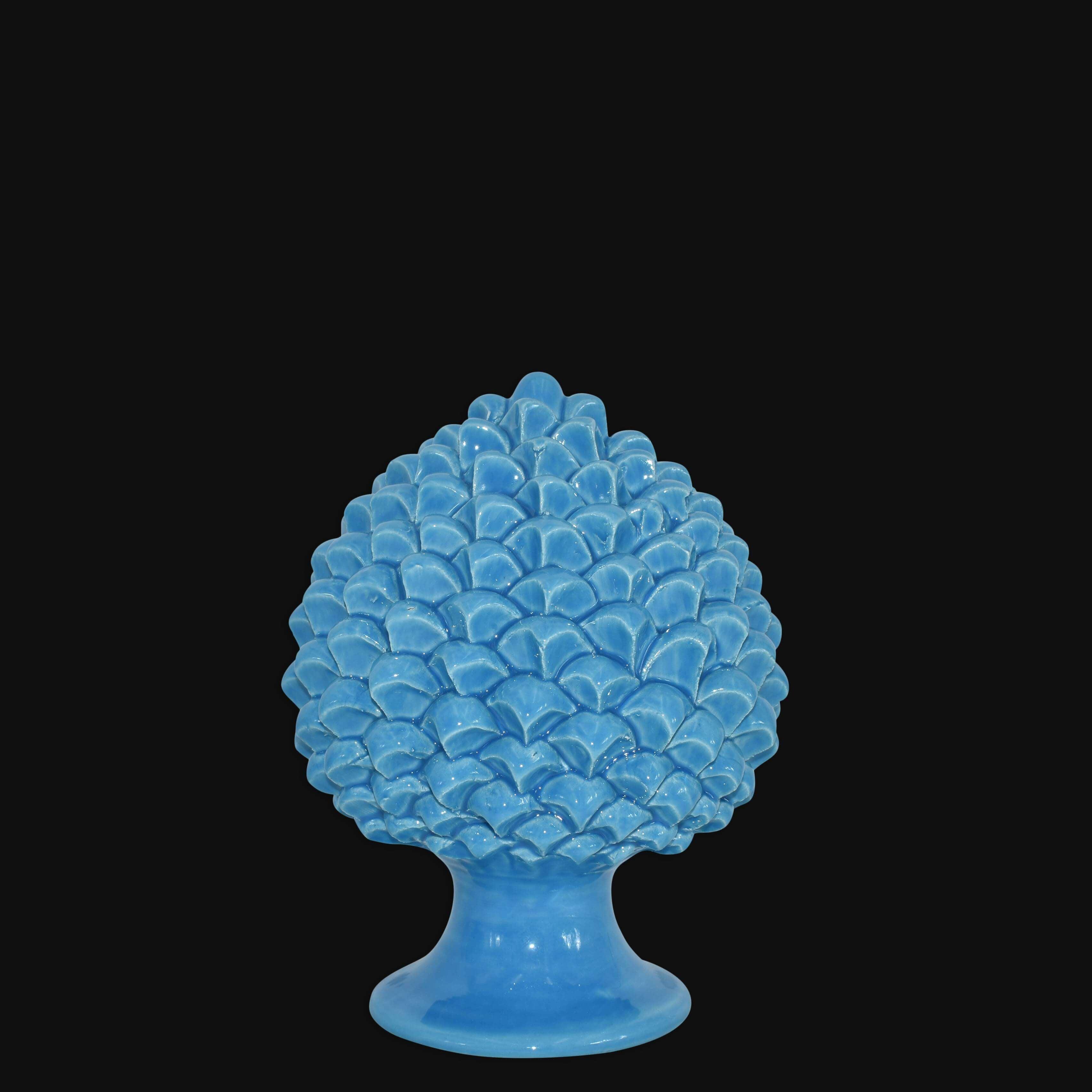 Pigna artigianale turchese in ceramica di Caltagirone fatti a mano su sfondo nero.