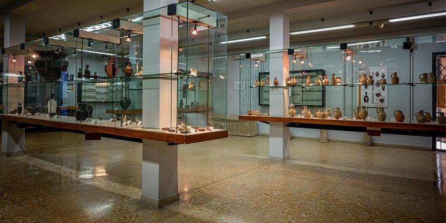 Museo con esposizione di ceramiche di Caltagirone fatti a mano in vetrine luminose su pareti e pilastri